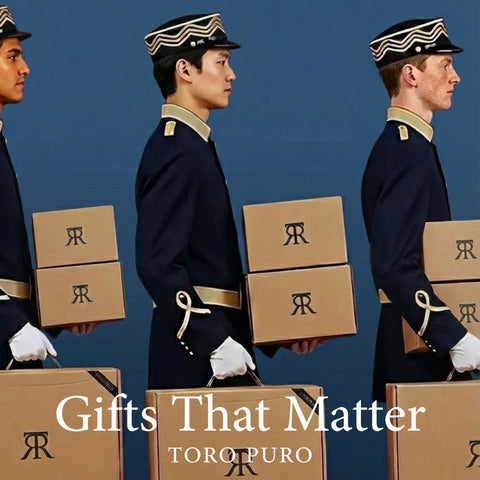 Three men in formal uniforms holding boxes with 'Gifts That Matter' and 'TORO PURO' text on a blue background.