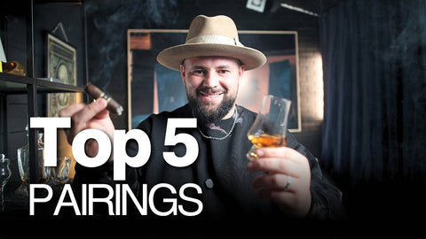 Man holding a glass of whiskey with text 'Top 5 Pairings' in a dark, stylish setting.