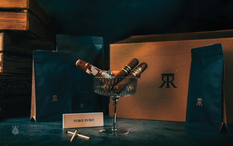 Cigars in a glass with a box and packaging in the background