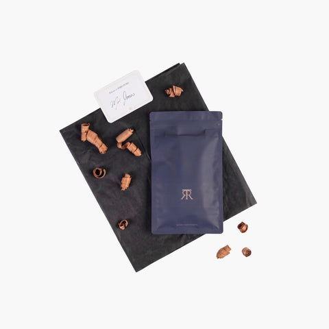Black and blue packaging with small brown objects on a white background