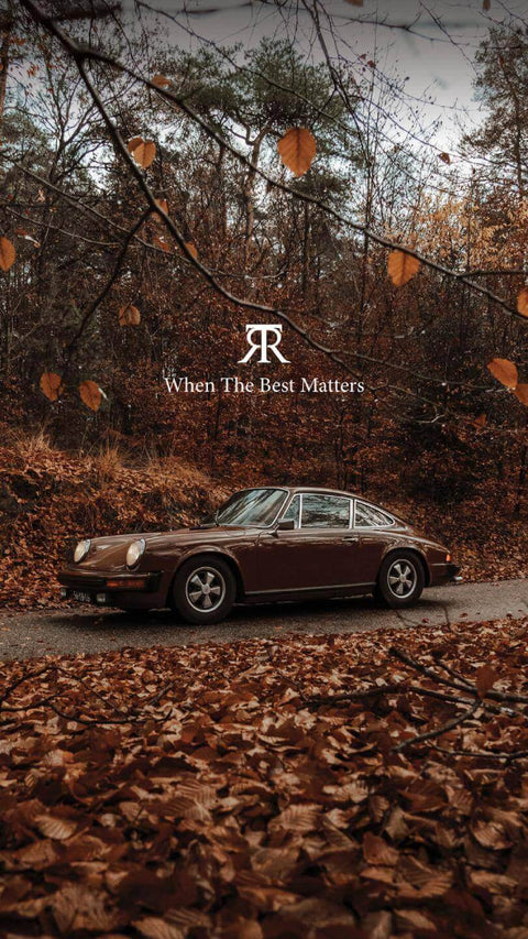 Vintage car parked on a leaf-covered road with autumn trees and '~Toro Puro's logo with text.