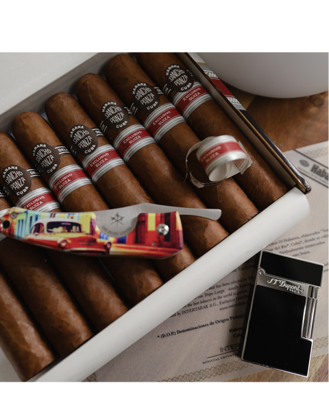 Box of cigars with a knife and lighter on a wooden surface.